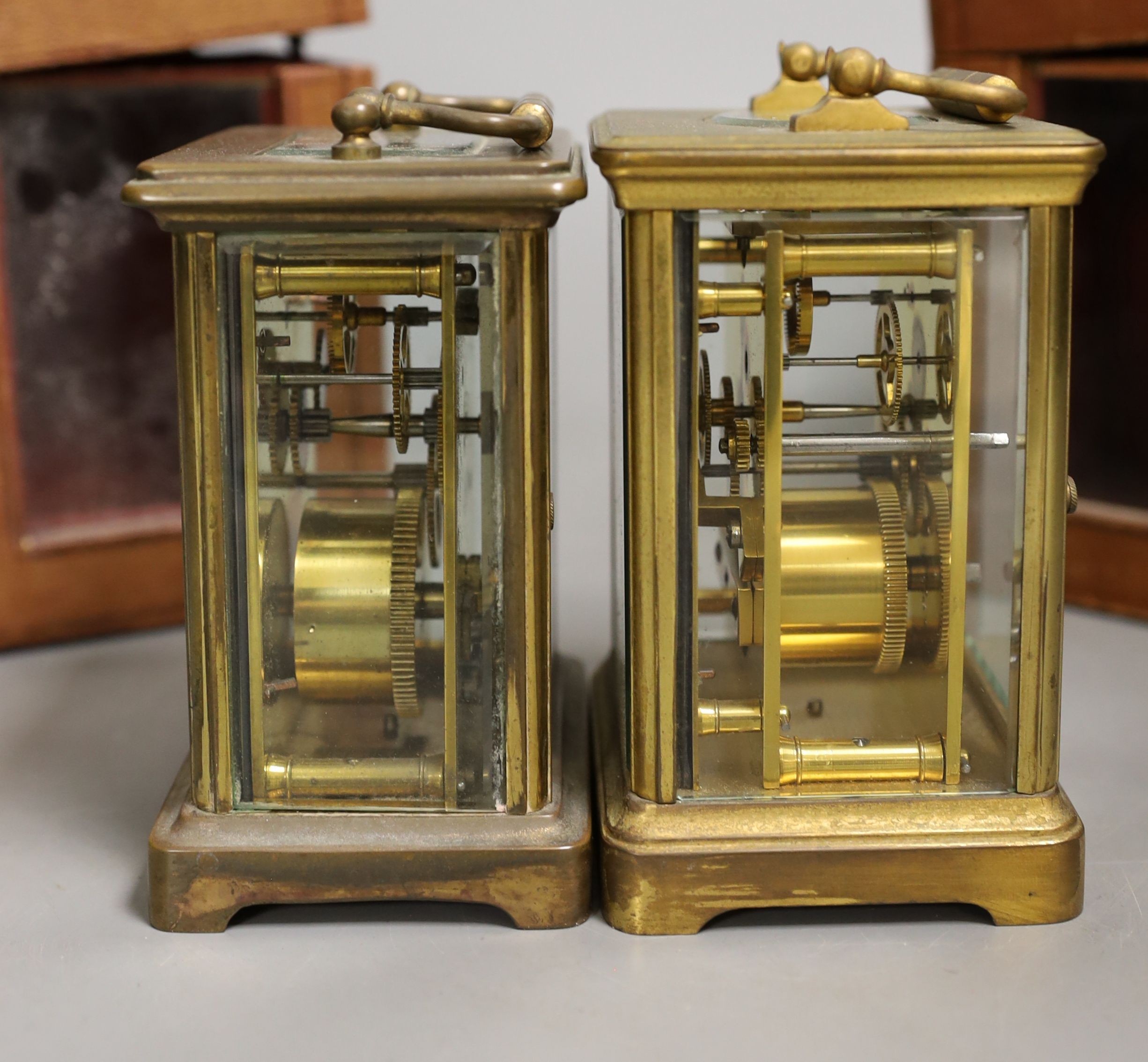Two leather cased brass carriage timepieces, 14 cms high including case.
